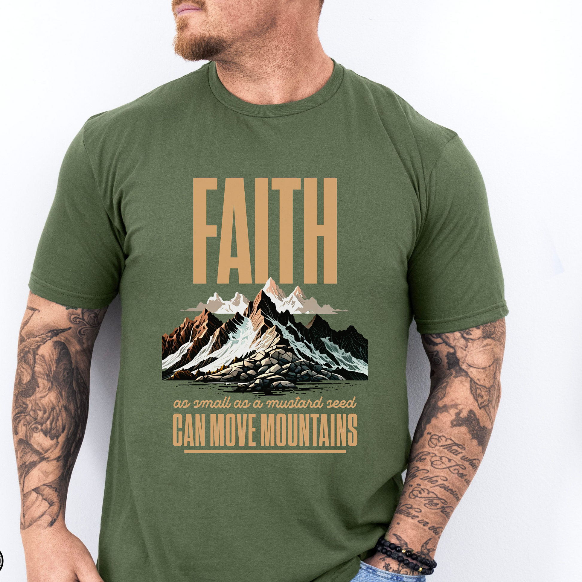 A green tshirt that says Faith as small as a mustard seed can move mountains. It has a mountain range design on it.